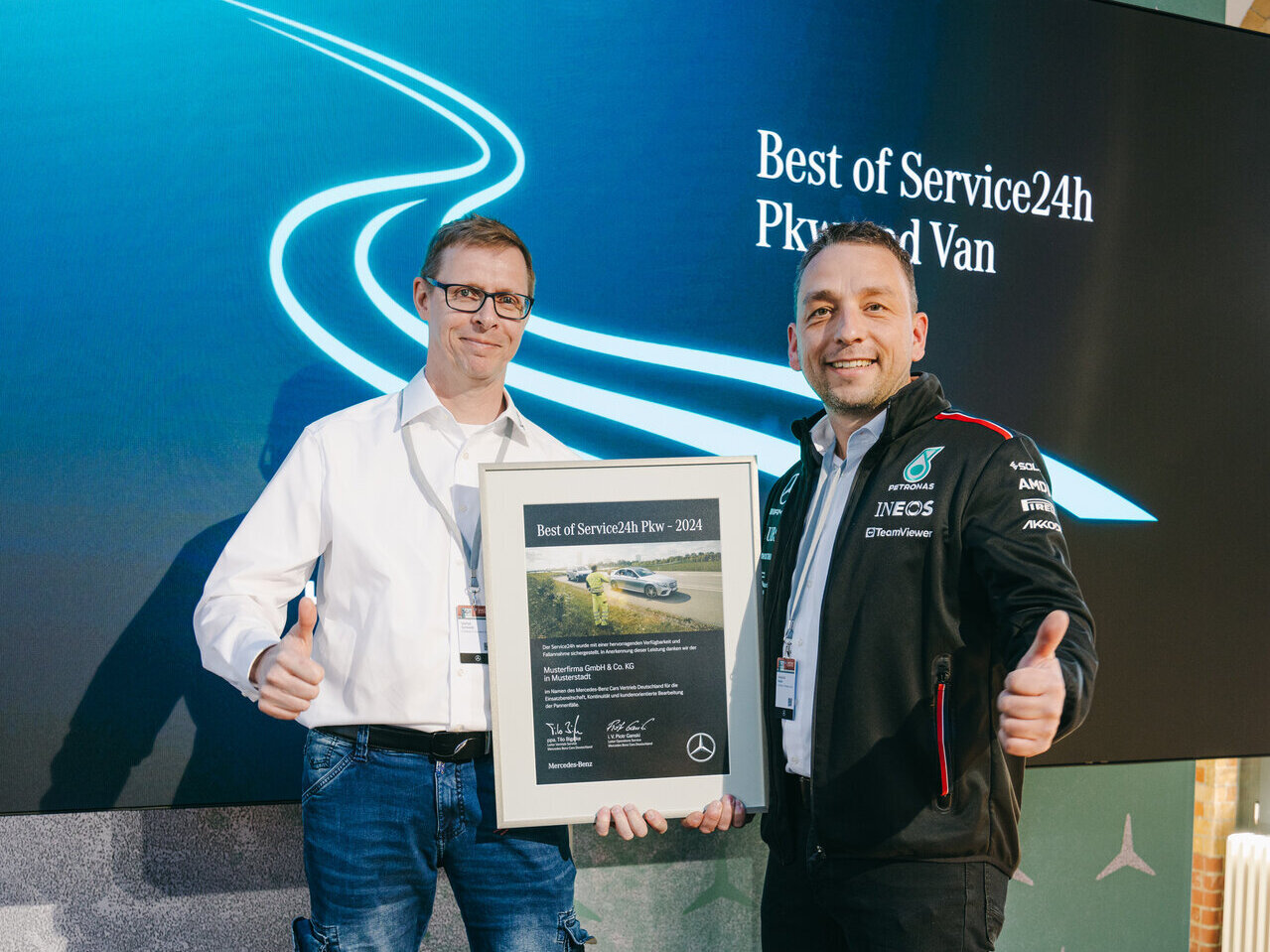 Zwei Männer halten den Preis für den "Best of Service24h 2024" hoch